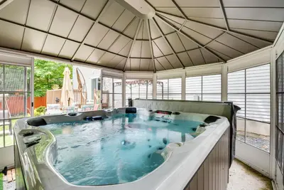 a large hot tub in a room with windows at Hot Tub, Game Room and Fire Pit Pocono Summit Home! in Pocono Summit