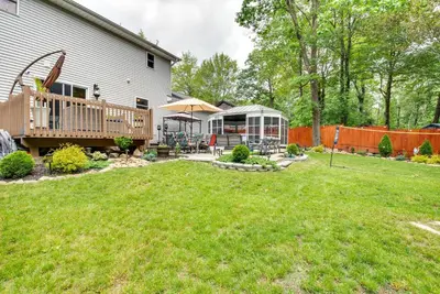 a backyard with a deck and a house at Hot Tub, Game Room and Fire Pit Pocono Summit Home! in Pocono Summit