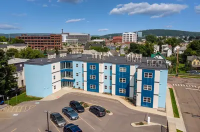 a large building with cars parked in a parking lot at Grand Monarch! Best for Extended Stays! in Johnson City