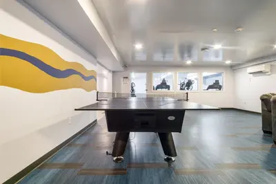 a ping pong table in the middle of a room at Grand Monarch! Best for Extended Stays! in Johnson City