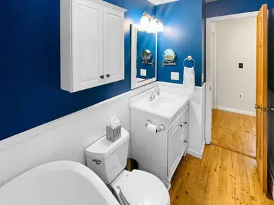 a bathroom with a white toilet and a sink at Haven Retreat in Catskills w Hot Tub & Bar Hall in Sundown