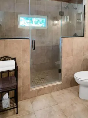 a bathroom with a shower and a toilet at Haven Retreat in Catskills w Hot Tub & Bar Hall in Sundown