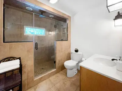 a bathroom with a shower and a toilet and a sink at Haven Retreat in Catskills w Hot Tub & Bar Hall in Sundown