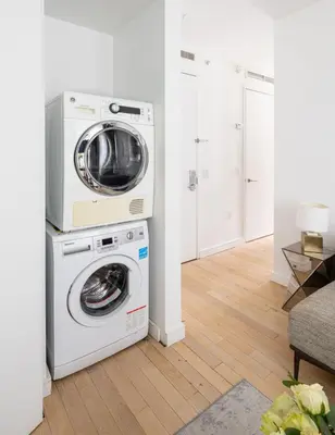 a washing machine and a washer in a room at Beautiful 2BD with a Gym near Times Square in New York