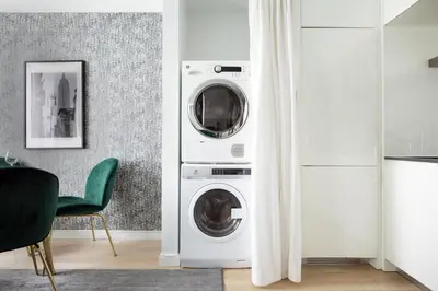 a kitchen with a washer and dryer in a room at Stylish 2BD with Washer and Dryer near Times Square in New York