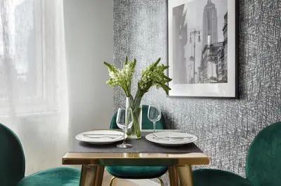 a table with plates and glasses and a vase of flowers at Stylish 2BD with Washer and Dryer near Times Square in New York