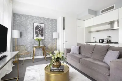 a living room with a couch and a table at Perfectly located 2BD near Times Square with Gym in New York