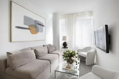 a living room with a couch and a table at Modern 2BD in Midtown with Washer and Dryer in-unit in New York