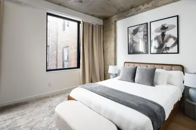 a bedroom with a large bed and a window at Chic and Spacious 2BD Apt with washer and dryer in unit in New York