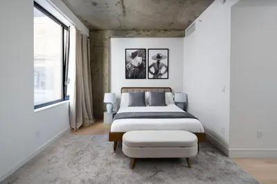 a bedroom with a bed and a large window at Chic and Spacious 2BD Apt with washer and dryer in unit in New York