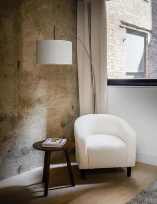 a living room with a white chair and a table at Chic and Spacious 2BD Apt with washer and dryer in unit in New York