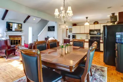 a kitchen and dining room with a table and chairs at Fire Pit, Kayaks and Hammocks Long Pond Home! in Long Pond