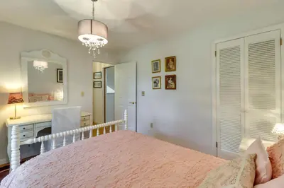 a bedroom with a pink bed and a desk at Fire Pit, Kayaks and Hammocks Long Pond Home! in Long Pond