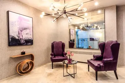 a waiting room with purple chairs and a mirror at Upper W Side 1BR w Gym by Lincoln Sq NYC-331 in New York