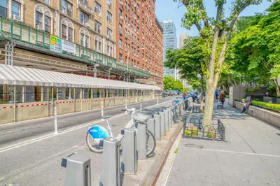 a row of bikes parked on a city street at Upper W Side 1BR w Gym by Lincoln Sq NYC-331 in New York