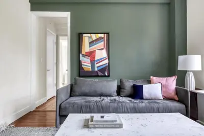 a living room with a couch and a table at Upper W Side 1BR w Gym by Lincoln Sq NYC-331 in New York