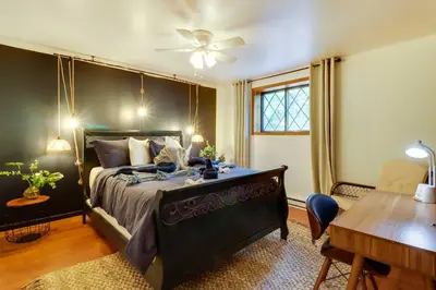 a bedroom with a large bed with a ceiling fan at Game Room and Hot Tub Ski Getaway in Poconos! in East Stroudsburg