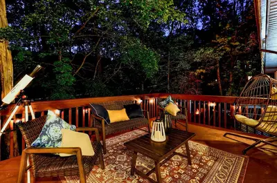 a porch with chairs and a table and a swing at Game Room and Hot Tub Ski Getaway in Poconos! in East Stroudsburg