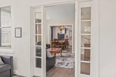 a living room with a door leading to a dining room at King Bed Gym Parking AC Train in Narberth