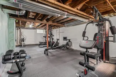 a gym with several exercise equipment in a room at King Bed Gym Parking AC Train in Narberth