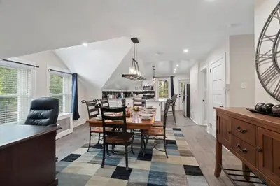 a dining room and kitchen with a table and chairs at Spacious Home King Beds Gym Deck Games Parking AC in Narberth