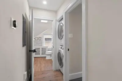 a laundry room with a washer and dryer in it at Spacious Home King Beds Gym Deck Games Parking AC in Narberth