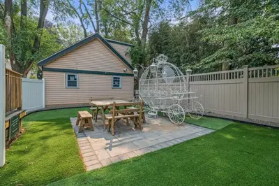 a backyard with a picnic table and a fence at Spacious Home King Beds Gym Deck Games Parking AC in Narberth