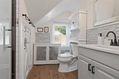 a white bathroom with a toilet and a sink at 5 Star Penthouse King Deck AC Train in Narberth