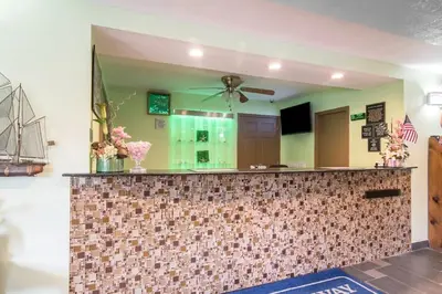 a kitchen with a tile counter with a ceiling fan at Rodeway Inn Towanda in Towanda