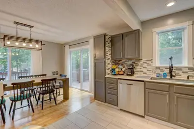 a kitchen and dining room with a table and chairs at Cozy Chalet Game Rm and Fireplace in East Stroudsburg