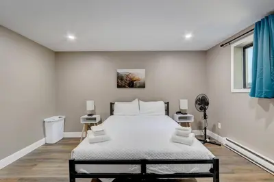 a white bedroom with a large bed in it at Cozy Chalet Game Rm and Fireplace in East Stroudsburg