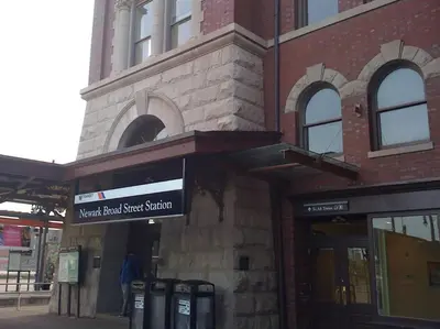a building with a sign on the front of it at Collect3 2BR 1BA Close to Train and NYC in Newark