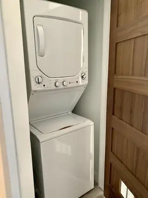 a white refrigerator with a tv on top of it at Collect3 2BR 1BA Close to Train and NYC in Newark