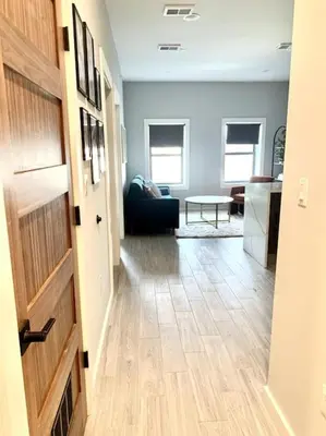 a hallway with a living room and a kitchen at Collect3 2BR 1BA Close to Train and NYC in Newark