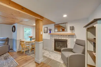 a living room with a fireplace and a table at Charming Manheim Cottage with On-Site Animal Viewing in Manheim