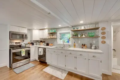 a kitchen with white cabinets and a sink at Charming Manheim Cottage with On-Site Animal Viewing in Manheim