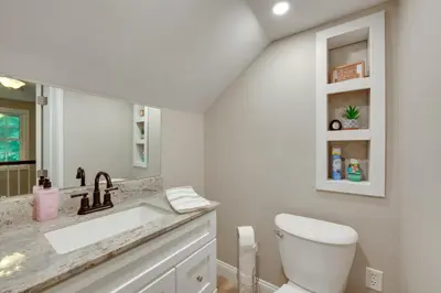 a white bathroom with a sink and a toilet at Charming Manheim Cottage with On-Site Animal Viewing in Manheim