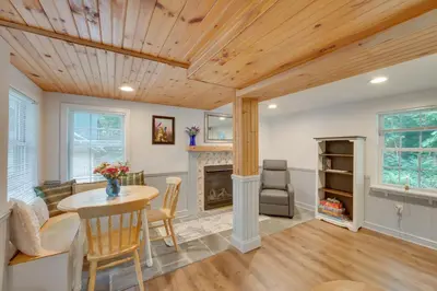 a dining room with a table and a fireplace at Charming Manheim Cottage with On-Site Animal Viewing in Manheim