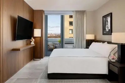 a bedroom with a large white bed and a window at Park Hyatt New York in New York