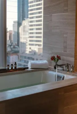 a bathroom with a bath tub with a view of a city at Park Hyatt New York in New York