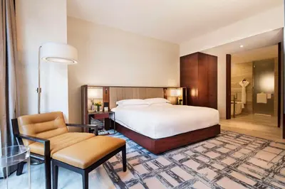 a hotel room with a bed and a chair at Park Hyatt New York in New York