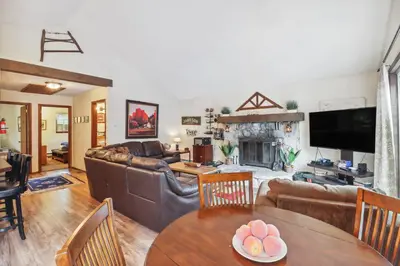 a living room with leather furniture and a fireplace at Tobyhanna Home with Fire Pits - 9 Mi to Kalahari! in Tobyhanna