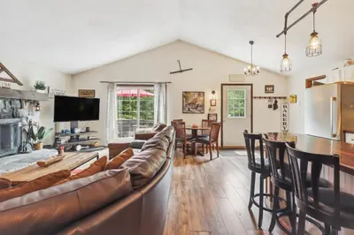 a living room with a couch and a bar at Tobyhanna Home with Fire Pits - 9 Mi to Kalahari! in Tobyhanna