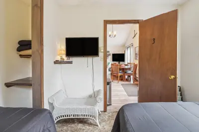 a bedroom with a bed and a television on a wall at Tobyhanna Home with Fire Pits - 9 Mi to Kalahari! in Tobyhanna