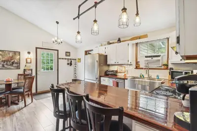 a kitchen with a wooden counter top in a room at Tobyhanna Home with Fire Pits - 9 Mi to Kalahari! in Tobyhanna