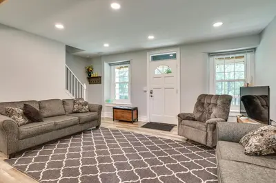 a living room with two couches and a tv at Large Historic Home in Pennsylvania Dutch Country! in Coatesville