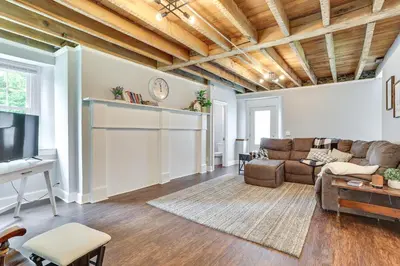 a living room with a couch and a tv at Large Historic Home in Pennsylvania Dutch Country! in Coatesville