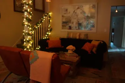 a living room with a couch and christmas lights at The Frogtown Inn in Canadensis