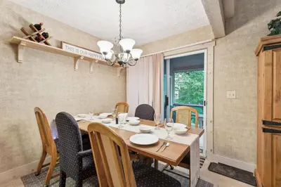 a dining room with a table and chairs at Lake Harmony Home with Screened Porch and Hot Tub! in Lake Harmony