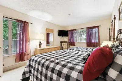 a bedroom with a black and white checkered bed at Lake Harmony Home with Screened Porch and Hot Tub! in Lake Harmony